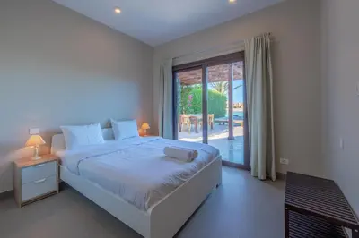 a bedroom with a bed and a large window at 3BR Family Villa in Sabina, El Gouna. Lagoon & Private Pool in Hurghada