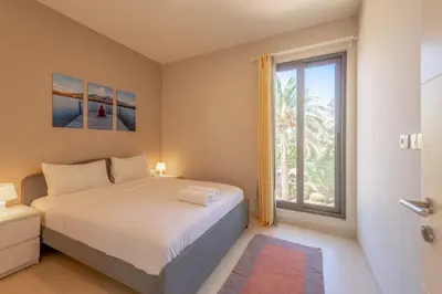 a bedroom with a bed and a large window at Light-Filled 4-Bedroom Villa in Tawila, El Gouna. Jacuzzi & Lagoon in Hurghada