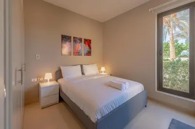a bedroom with a large bed and a window at Light-Filled 4-Bedroom Villa in Tawila, El Gouna. Jacuzzi & Lagoon in Hurghada