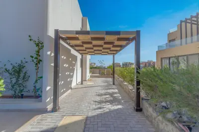 a walkway with awning on the side of a building at Light-Filled 4-Bedroom Villa in Tawila, El Gouna. Jacuzzi & Lagoon in Hurghada