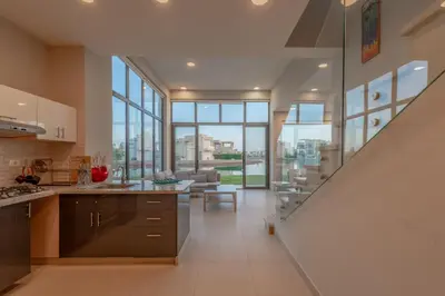 a kitchen with a staircase leading to a living room at Light-Filled 4-Bedroom Villa in Tawila, El Gouna. Jacuzzi & Lagoon in Hurghada
