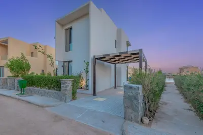 a white house with a entrance to a driveway at Light-Filled 4-Bedroom Villa in Tawila, El Gouna. Jacuzzi & Lagoon in Hurghada