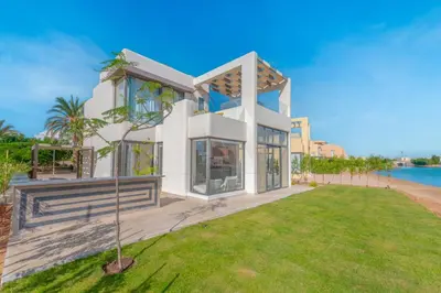 a house with a view of the water at Light-Filled 4-Bedroom Villa in Tawila, El Gouna. Jacuzzi & Lagoon in Hurghada