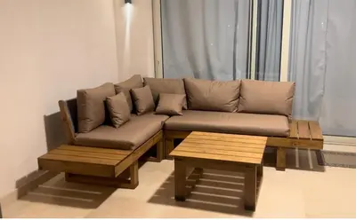 a brown couch and a coffee table in a living room at Luxurious Sea view 2 BR & private Garden to the pool at Mangroovy in Hurghada