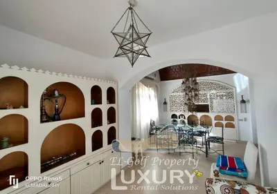 a living room with a table and a dining room at Villa 4 Bed Rooms-North Golf-GN24 in Hurghada