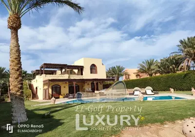 a villa with a swimming pool and a palm tree at Villa 4 Bed Rooms-North Golf-GN24 in Hurghada