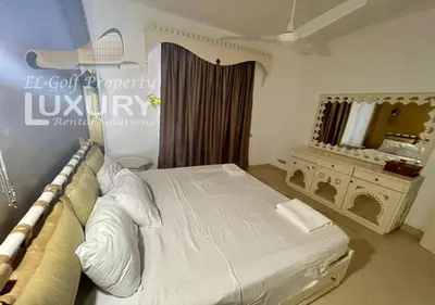 a bedroom with a large bed and a mirror at Villa 4 Bed Rooms-North Golf-GN24 in Hurghada