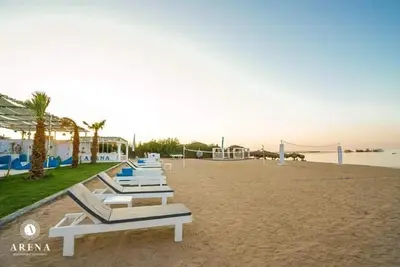 a row of lounge chairs on a beach at Selena Bay Resort luxury 1 bedroom Apartments in Hurghada