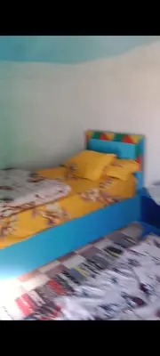 a bedroom with a bed with a blue frame at بيت شمس in Aswan