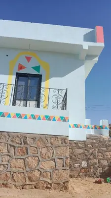 a building with a window and a stone wall at بيت شمس in Aswan