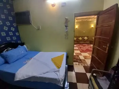 a small bedroom with a bed and a door to a room at Sabrina home in Aswan