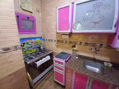 a toy kitchen with a stove and a sink at Sabrina home in Aswan