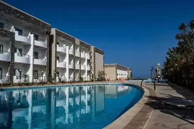 a swimming pool in front of a building at Cecelia resort in Hurghada