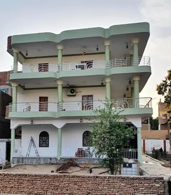 a building with a balcony on top of it at Family House in Luxor