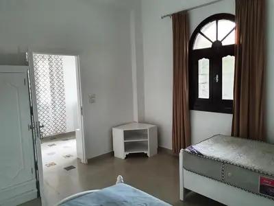 a bedroom with a bed and a window at Family House in Luxor