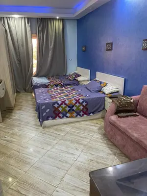 a bedroom with two beds and a couch at منتجع سيسيليا cecelia resort in Hurghada