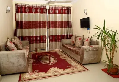 a living room with two couches and a television at Egypt sun accommodation Spiritualities in Luxor