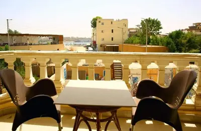 a table and chairs sitting on a balcony at Egypt sun accommodation Spiritualities in Luxor