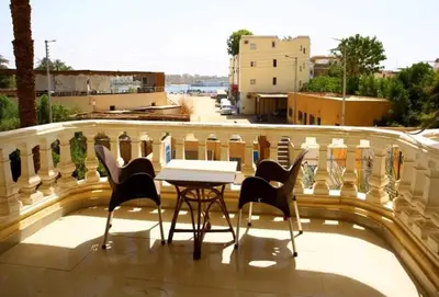a table and chairs on top of a balcony at Egypt sun accommodation Spiritualities in Luxor