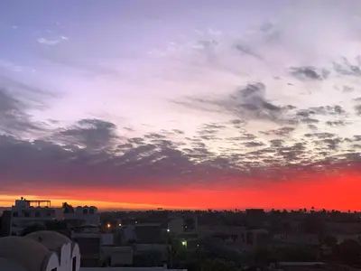 a view of a sunset from a city at Temple House Luxor in Luxor