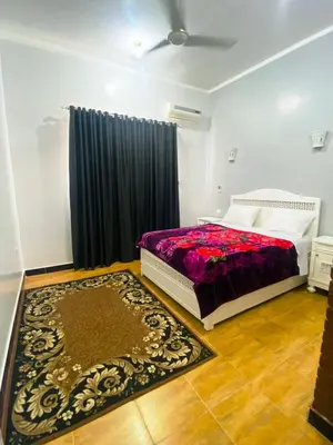 a bedroom with a bed and a rug at Temple House Luxor in Luxor