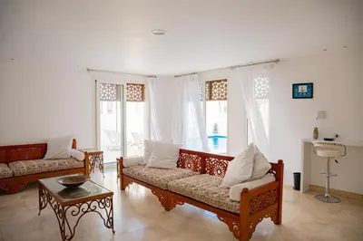 a living room with two couches and a table at Nayah Stays, Amazing villa with private pool & 5 master suites in Hurghada