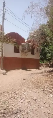 a house on the side of a dirt road at Hamd Nubian Guest House in Aswan