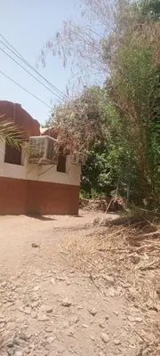 a house sitting on the side of a dirt road at Hamd Nubian Guest House in Aswan