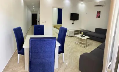 a living room with a table and chairs and a couch at selena bay in Hurghada