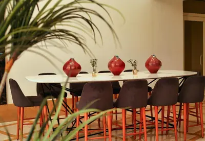 a table with red vases on top of it at New Eagles Downtown Zahabia Resort & Aqua Park in Hurghada