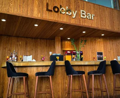 a bar with four stools in front of a restaurant at New Eagles Downtown Zahabia Resort & Aqua Park in Hurghada