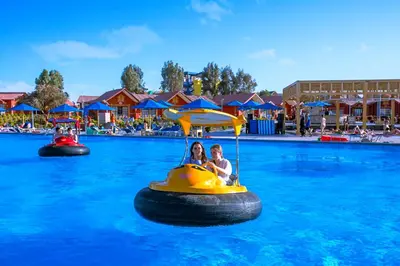 two people riding on a raft in the water at an amusement park at Neverland City Hurghada - Pickalbatros in Hurghada