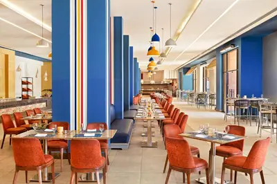 a restaurant with tables and chairs and blue walls at Neverland City Hurghada - Pickalbatros in Hurghada