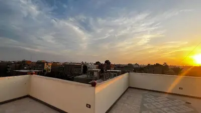 a view of the sunset from the roof of a building at Masa House Luxor in Luxor