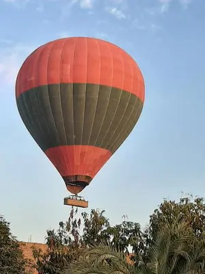 a hot air balloon flying in the sky at Masa House Luxor in Luxor