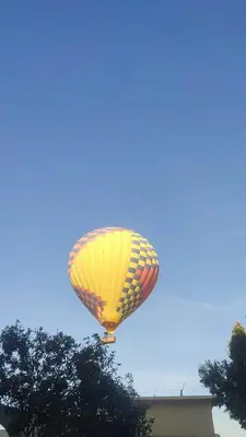 a yellow balloon is flying in the sky at Masa House Luxor in Luxor