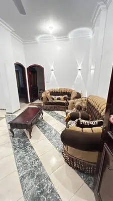 a living room with two couches and a coffee table at Masa House Luxor in Luxor