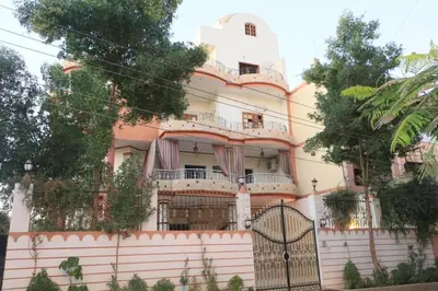 a large house with a fence in front of it at Masa House Luxor in Luxor