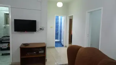 a living room with a television on a white wall at new ikea flat 1 in Hurghada