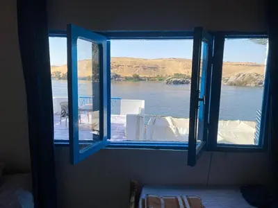 an open window with a view of a body of water at hooly nubian in Aswan