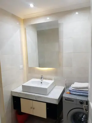 a bathroom with a sink and a washing machine at Tawaya sahl hashesh in Hurghada