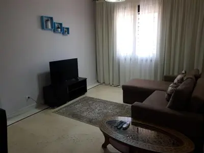 a living room with a couch and a tv at Tawaya sahl hashesh in Hurghada