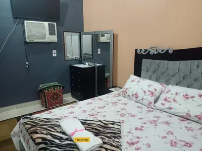a bedroom with a bed and a mirror at Rema Nubian Guest House in Aswan