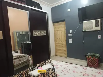 a room with a bed and a door with a window at Rema Nubian Guest House in Aswan