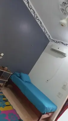 a bedroom with a blue bed in a room at Rema Nubian Guest House in Aswan