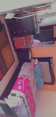 an open drawer with a bed in a room at Rema Nubian Guest House in Aswan