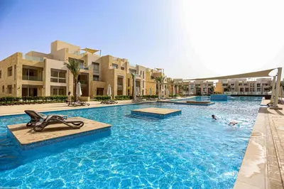 a pool at a resort with people swimming in it at Mangarovy El Gouna in Hurghada