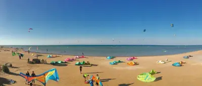 a group of people on a beach with kites at Lagoon View Penthouse - El Gouna Paradise Escape in Hurghada