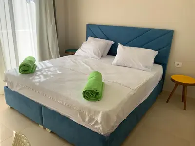 a blue bed with two green towels on it at Elgouna Hurghada egypt mangroovy in Hurghada