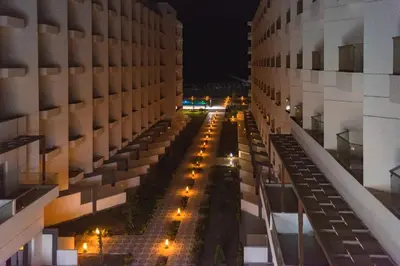 a view of a street between two buildings at night at The Comfortable palace in Hurghada